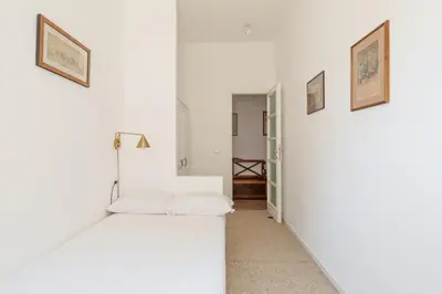 a room with white walls and a white couch at Bright Family 5BR Apartment in Parioli in Rome