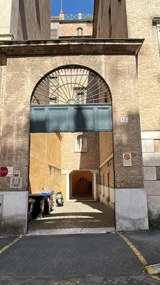 a large brick building with an archway on it at San Vitale 18 by GHOR in Rome