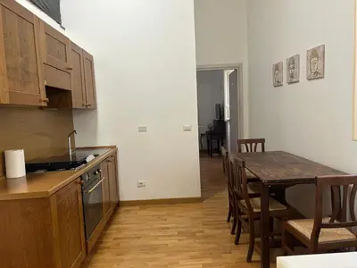 a kitchen with a table and a dining room at San Vitale 18 by GHOR in Rome