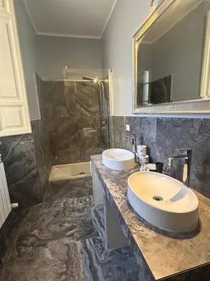 a bathroom with two sinks and a large mirror at San Vitale 18 by GHOR in Rome