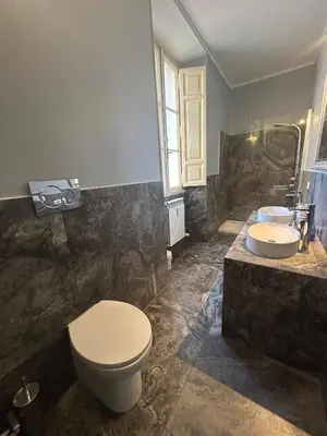 a bathroom with a toilet and a sink at San Vitale 18 by GHOR in Rome