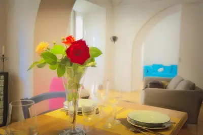 a vase with a red rose in it on a table at CasaBlanca Apartment in Rome