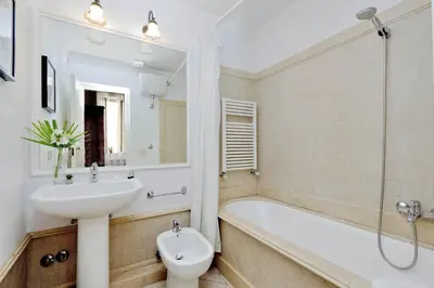 a bathroom with a sink and a tub and a toilet at Bollo in Rome