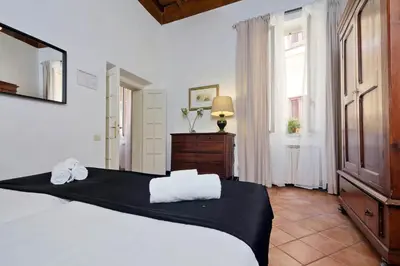 a bedroom with a white bed and a window at Bollo in Rome
