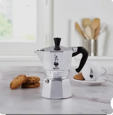 a coffee maker sitting on a counter with cookies at A Secret Corner in Rome