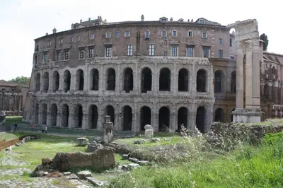 an old building with a large building in the background at A Secret Corner in Rome
