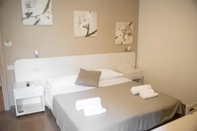 a bedroom with a bed with two white towels on it at Anna Guest House in Rome