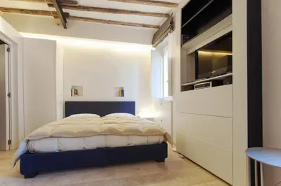 a small bedroom with a bed and a kitchen at Oro in Rome