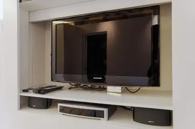 a flat screen tv sitting on a shelf at Oro in Rome