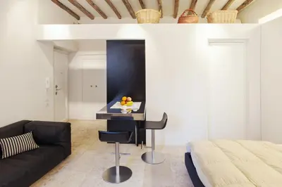 a bedroom with a bed and a desk and a couch at Oro in Rome