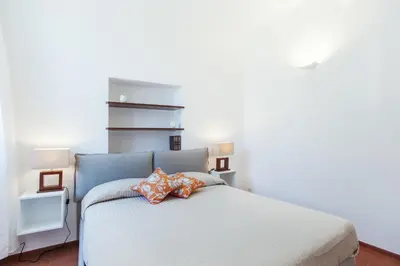 a bedroom with a bed with two pillows on it at Lungaretta3 in Rome