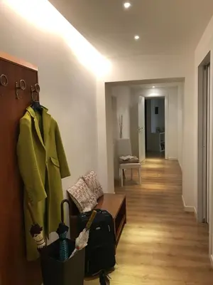 a living room with a couch and a coat on a wall at Charming 25 Apartment in Rome