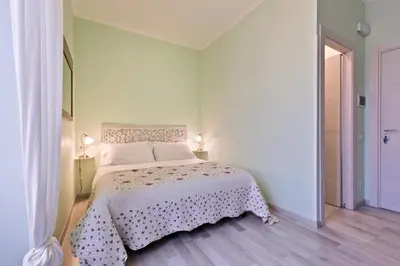 a bedroom with a bed with a white bedspread at A Roman Tale B&B in Rome