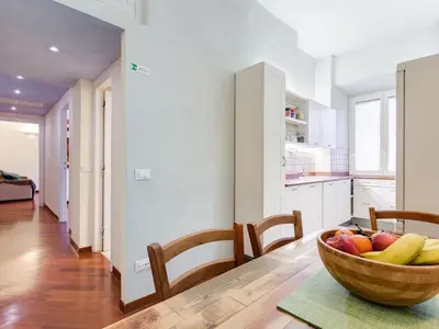 a kitchen with a wooden bowl of fruit on a table at Folia Domus in Rome