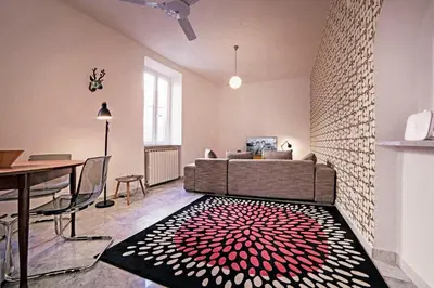 a living room with a couch and a red and white rug at TrastevereHome - Sales Rome in Rome
