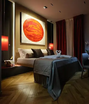 a bedroom with a bed and a painting on the wall at Navona Rooms in Rome