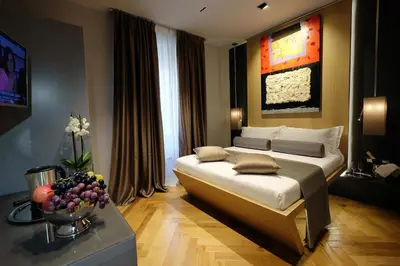 a bedroom with a bed and a bowl of fruit on a table at Navona Rooms in Rome