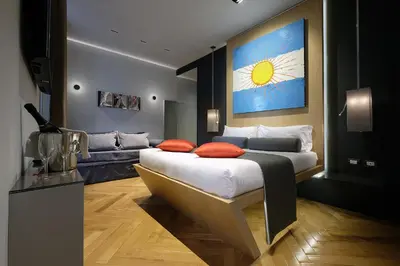 a bedroom with a bed and a couch at Navona Rooms in Rome