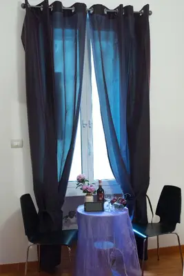 a table and two chairs in front of a window at Vatican Art Place in Rome