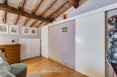 a living room with a white wall and a couch at Campo Marzio Boutique Apt 300 mt dal Pantheon in Rome