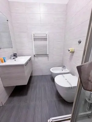 a white bathroom with a sink and a toilet at Ripetta 35 in Rome