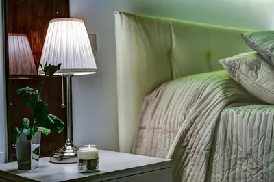 a bedroom with a bed and a table with a lamp at Good Life Monti in Rome