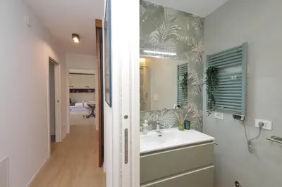 a bathroom with a sink and a mirror at Il Villino di Adelchi by DomusDimore in Rome