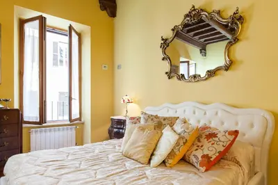 a bedroom with a bed with a mirror on the wall at Impero Vaticano Navona Apartment in Rome