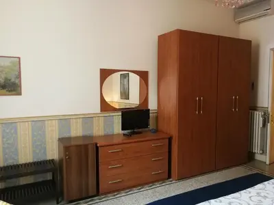 a bedroom with a dresser and a television on a cabinet at B&B La Bella Giuliana in Rome