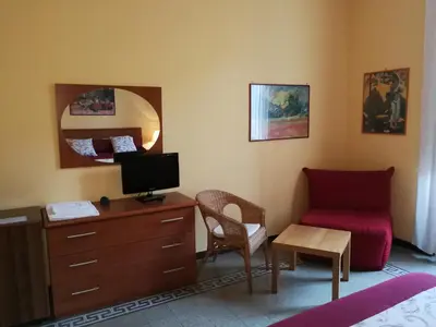 a bedroom with a desk and a chair and a couch at B&B La Bella Giuliana in Rome