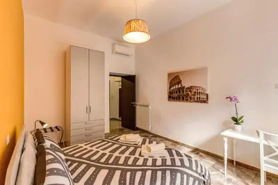 a bedroom with a bed and a desk at Domus Vita Romana in Rome