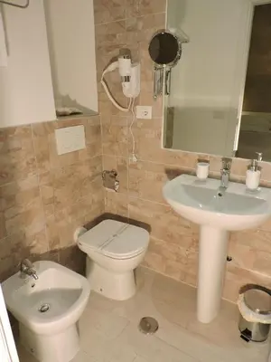 a bathroom with a toilet and a sink at Anfiteatro Suite in Rome