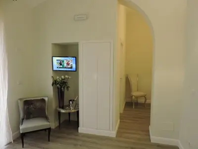 a hallway with a door and a table and chairs at Anfiteatro Suite in Rome