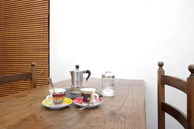 a wooden table with two cups of coffee on it at La Dolce Vista Trastevere in Rome