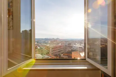 an open window with a view of a city at La Dolce Vista Trastevere in Rome