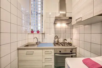 a small kitchen with a sink and a stove at M&L Apartment - Caracalla Holiday in Rome