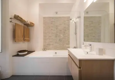 a white bathroom with a tub and a sink at Casa Oliva in Rome