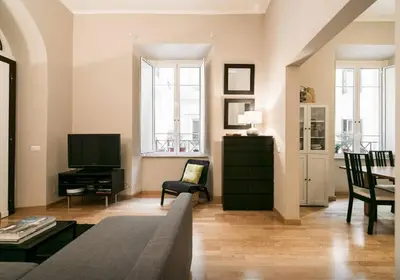 a living room with a couch and a television at Casa Oliva in Rome