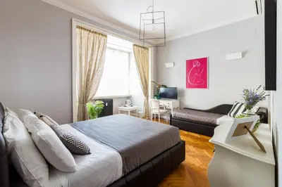 a bedroom with a bed and a couch at Athena Guest House in Rome