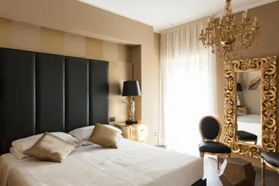 a bedroom with a large bed and a mirror at Town House Roma in Rome