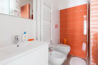 a bathroom with a toilet and a sink and a shower at Un Passino da San Pietro Casa in Rome