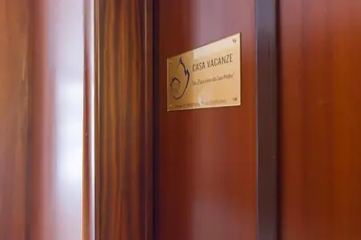 a sign on a door with a sign on it at Un Passino da San Pietro Casa in Rome
