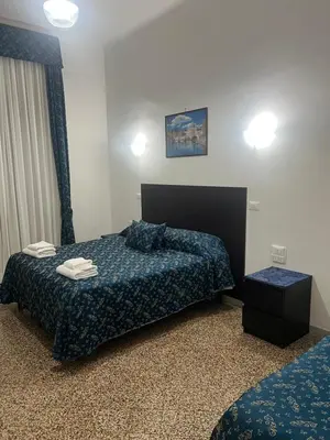 a hotel room with a bed and a night stand at Ines Downtown B&B in Rome