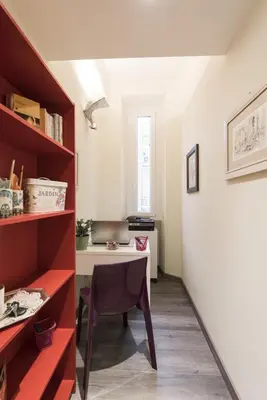 a small room with a table and a desk at Holidays in Rome - Guesthouse in Rome