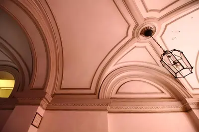 a ceiling in a building with a light fixture at Magenta Collection Del Grande in Rome