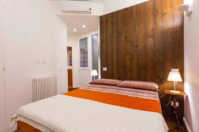 a bedroom with a bed with a wooden wall at Wake At Rome in Rome