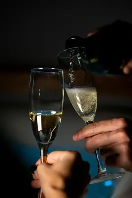 two people holding up glasses of white wine at New Design St.Peter in Rome