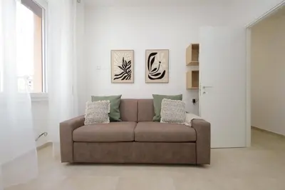 a living room with a brown couch in a room at Nancy Bleisure Suite by DomusDimore in Rome