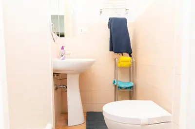 a bathroom with a white toilet and a sink at Piazza Farnese in Rome
