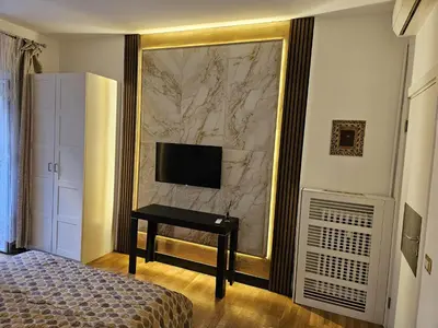 a bedroom with a bed and a couch and a window at Astoria Golden House in Rome
